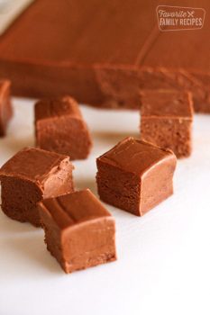 A pound of Sees fudge with square pieces arranged in front of it
