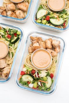 These Thai Peanut Chicken Meal Prep Bowls are a delicious grab-and-go meal. Crunchy slaw, sesame noodles, and chicken with an incredible easy peanut sauce!