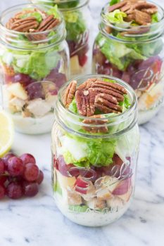 How to make an easy and healthy mason jar salad for make-ahead lunches! These Chicken Salad Mason Jar Salads with grapes, apple, and toasted pecans have a creamy, no mayo poppy seed dressing! | www.kristineskitchenblog.com
