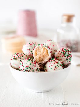 sugar cookie truffles with red and green sprinkles in a white bowl
