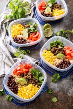 Easy taco meal prep bowls, with salsa verde beef and plenty of extras including corn, tomatoes, black beans, and cilantro